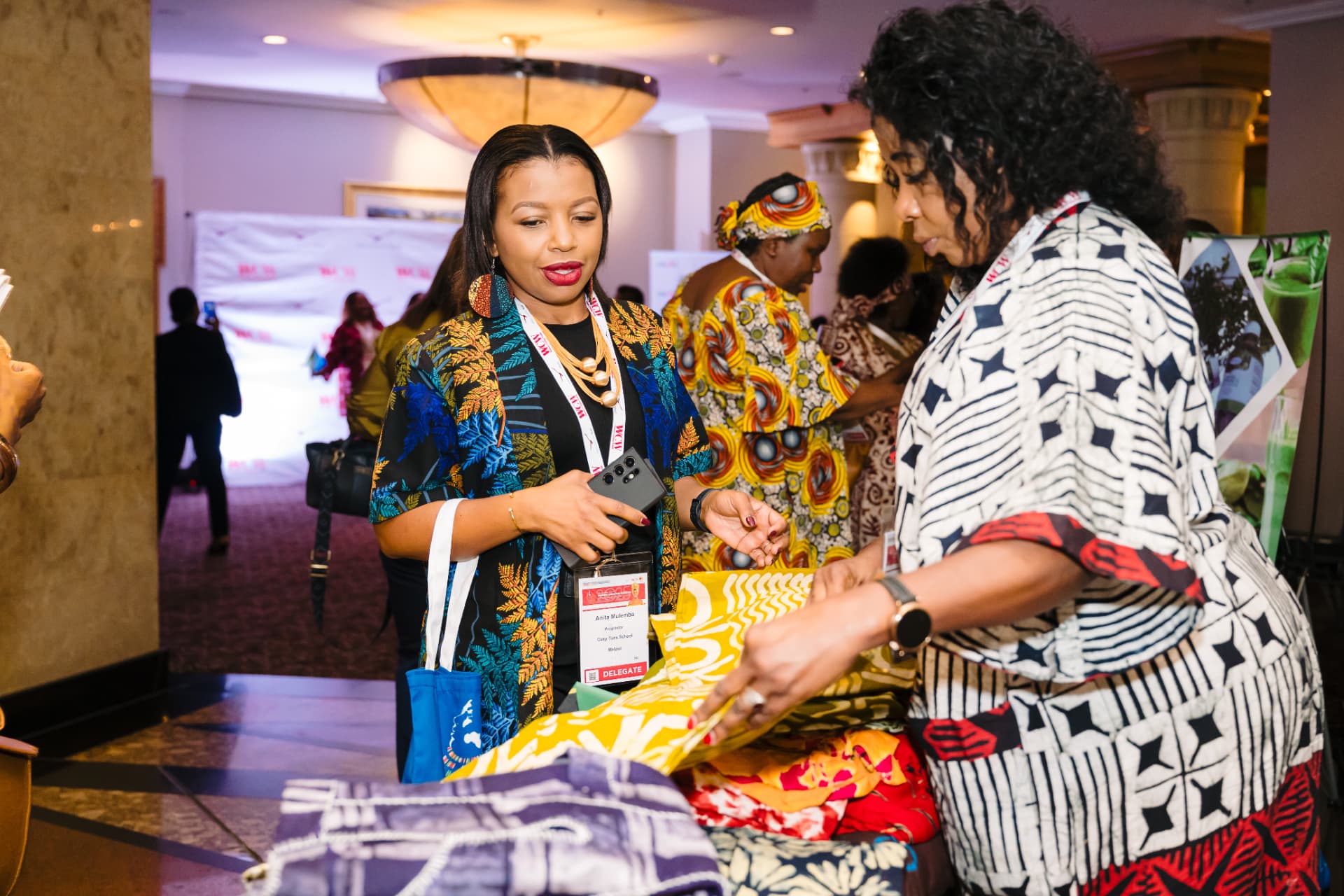 Women entrepreneurs reviewing a textile product at an exchange